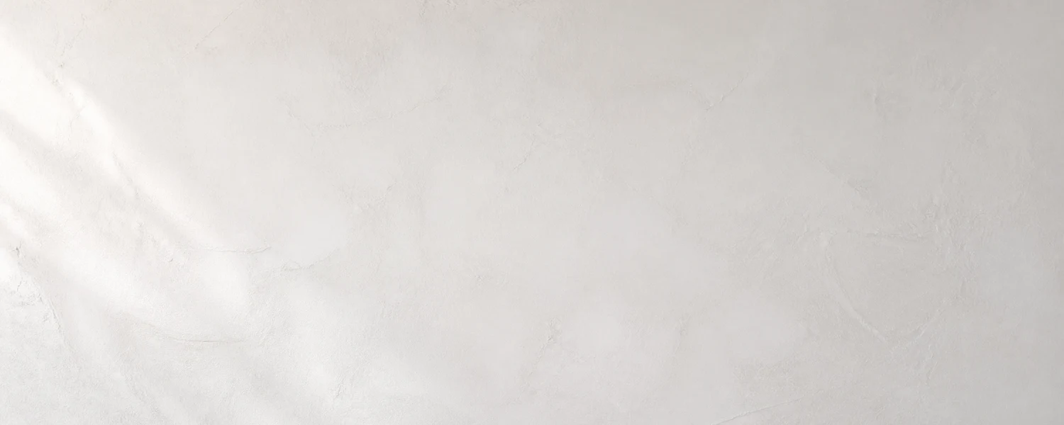 Smooth white plaster wall texture with soft side light