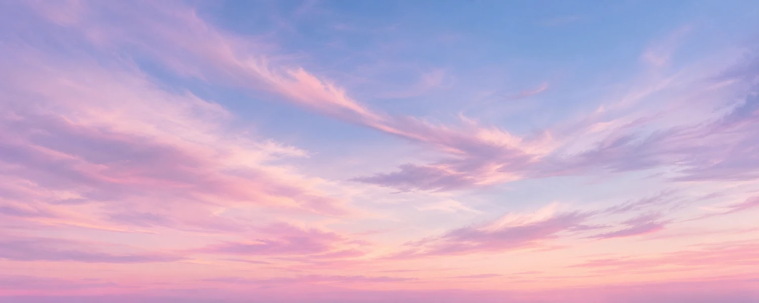 Pastel dusk sky with wispy clouds from pale pink to baby blue