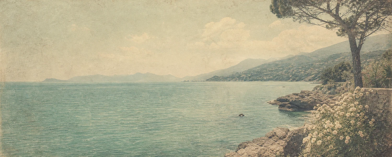 Faded vintage postcard style coastline with soft teal sea